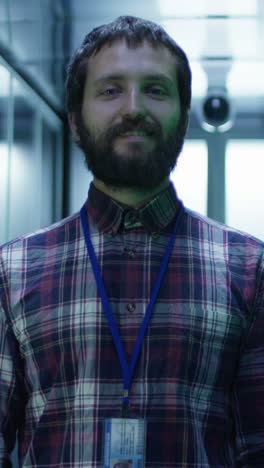 smiling it technician in server room