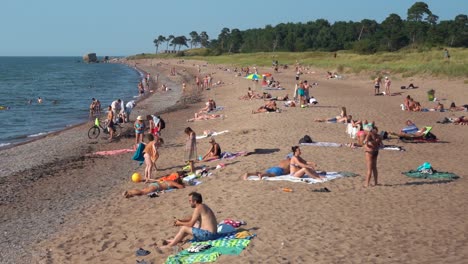liepaja, latvia august 9. 2020: people relax on the baltic beach in summer. crowd on the war port, north pole beach on weekend vacation