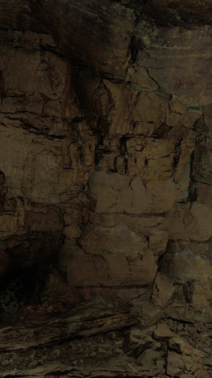 Exploring cave walls in a natural underground environment during the day