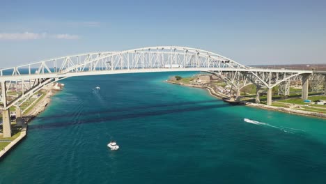 blue water bridge connecting port huron, michigan usa and sarnia, ontario canada with drone moving forward