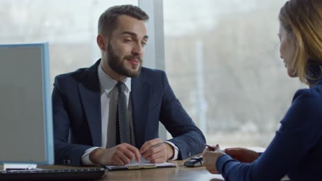 cheerful salesman chatting with customer in office