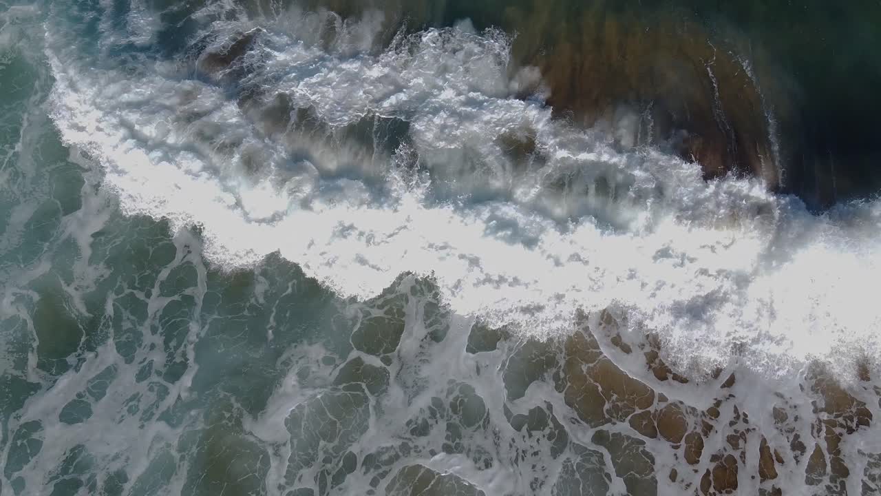 Wild and dangerous waves crashing ashore on a tropical beach