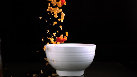 cereals and strawberries pouring in a bowl