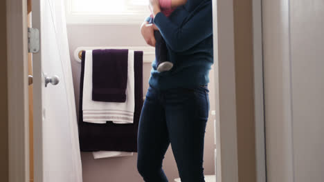 mother and daughter standing in bathroom