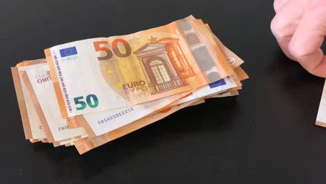 sorting and stacking a lot of 50 euro banknotes