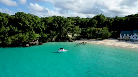 Boat-anchored-at-secluded-beachfront-house-in-Jamaica