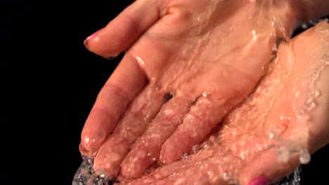 water pouring over female hands