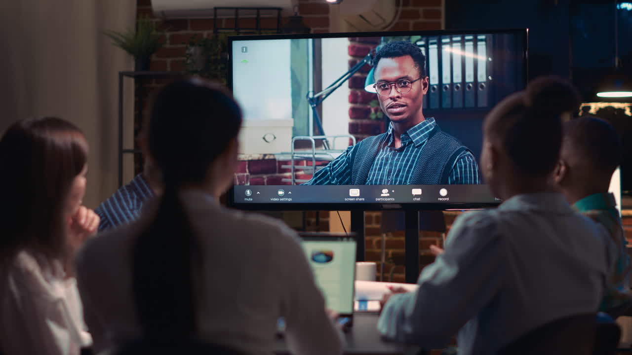 Remote team leader listening to employees report in videocall