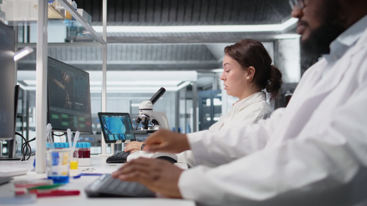 Vertical video Exhausted laboratory scientist rubbing eyes, tired at PC
