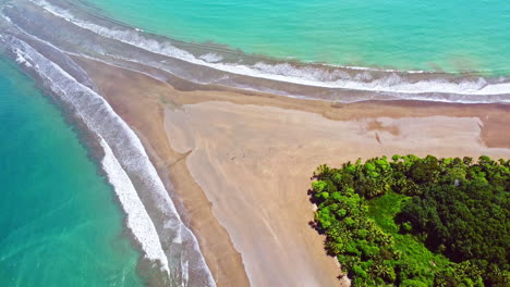 aerial drone footage revealing a beach shaped like a whale's tail in ballena marine national park, costa rica
