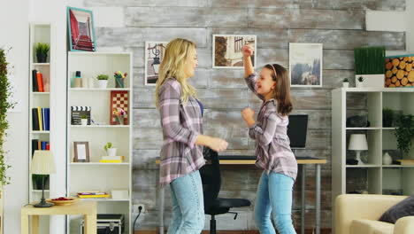 beautiful young mother dancing with her in the room