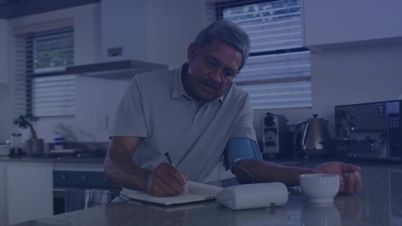 Senior man starting blood pressure cuff for health, recording readings, interpreting data overlays