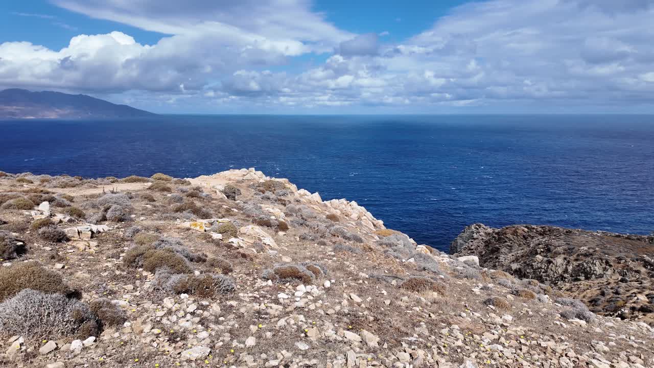 rustic cliffside shoreline of Mykonos, Greece, island view over arid coastal land