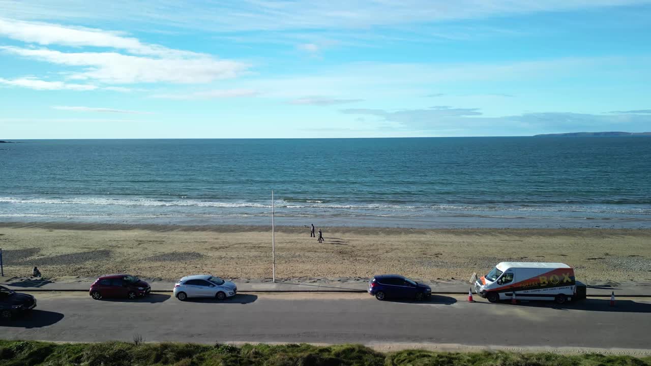 Garrylucas sandy beach drone flight over family playing on the beach and coastal road, Ireland
