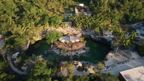 aerial shot of casa tortu structure inside of a lake with trees surrounding