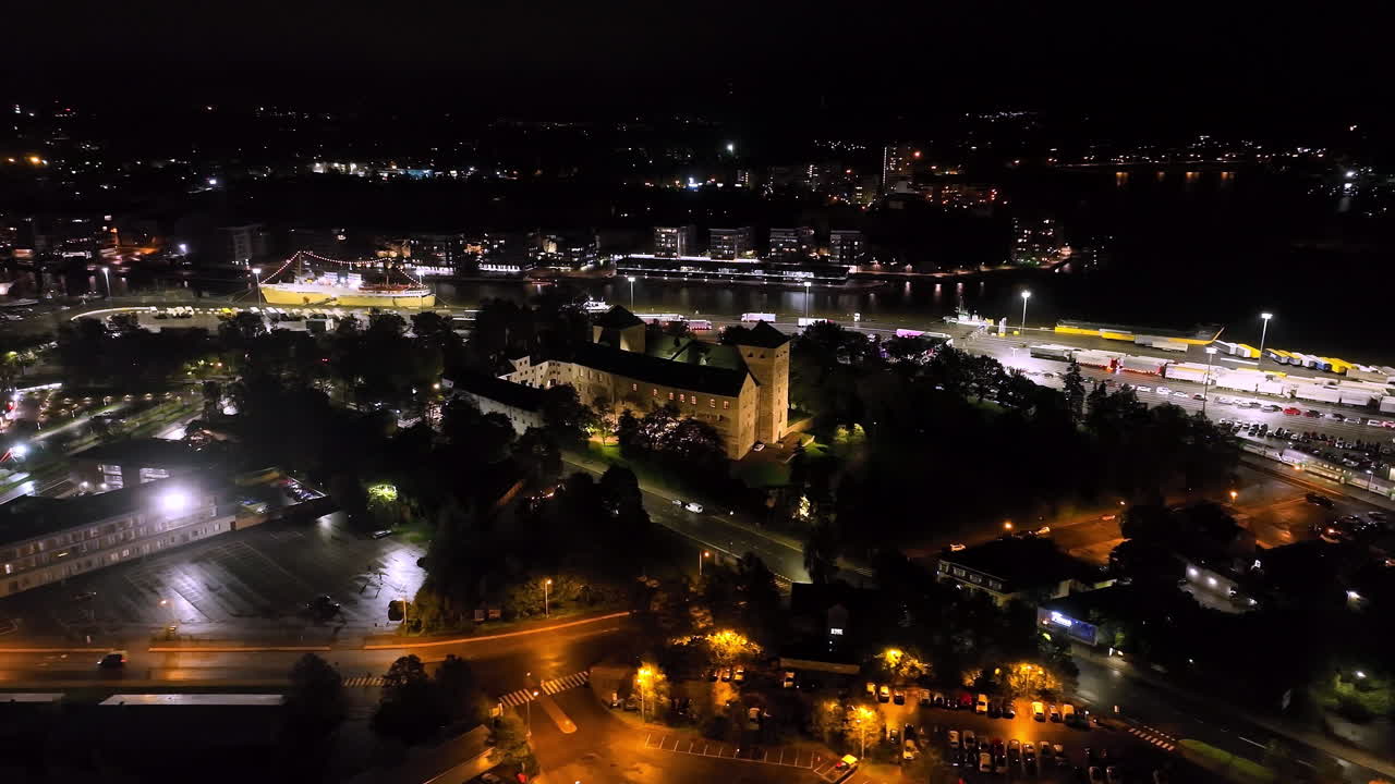 Panoramic drone shot circling the Turku castle, nighttime in Abo, Proper Finland
