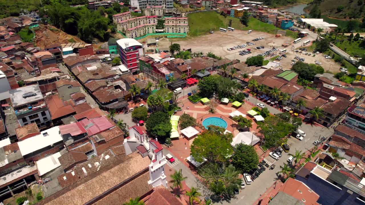 Colonial latin village of Guatape with pe&ntilde;ol rock in background at day time