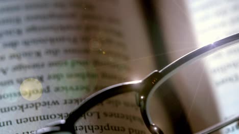 close-up of reading glasses on an open book