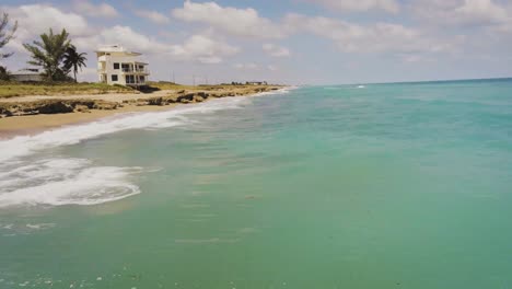 Jensen-Hutchinson-Island-coast-line-turquoise-water-alone-the-shoreline,-drone-view