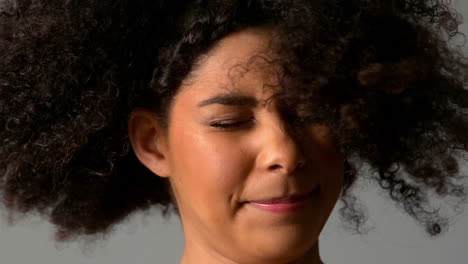 pretty girl with afro shaking her hair