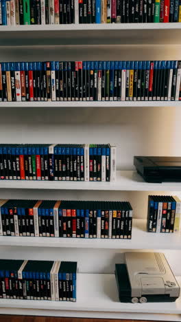vintage video game and media collection on bookshelf