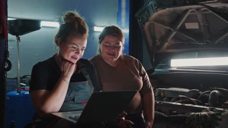 women auto mechanics working together in garage