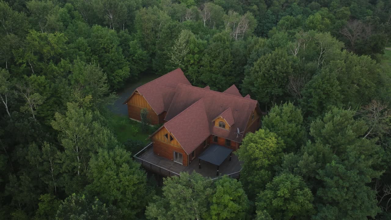Isolated Wooden Cabin With A Large Deck For Getaway Accommodation At Saint Croix Falls In Polk County, Wisconsin, United States. Aerial Drone Shot