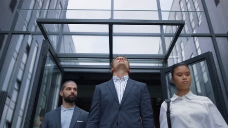 portrait frustrated businessman standing at office building throwing papers.