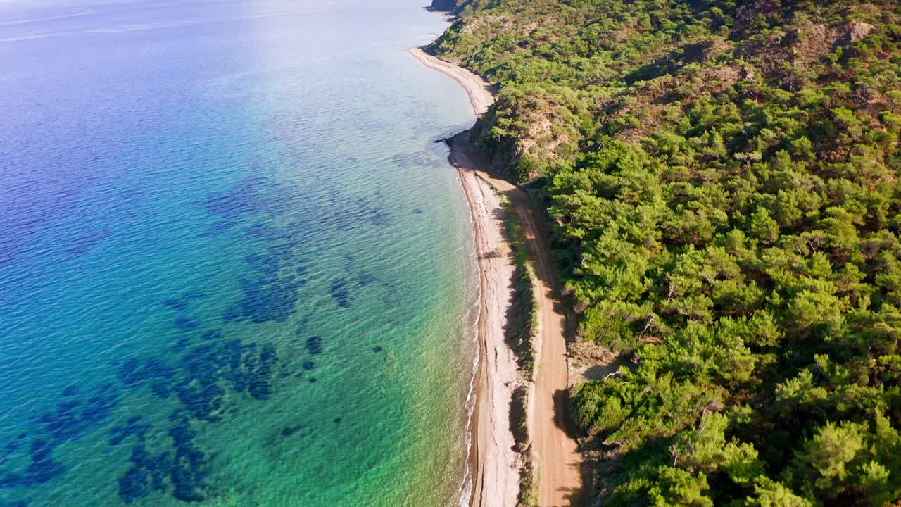 Flying along scenic azure mountainous coastline in Aegean Turkey, Gereme beach, Kızlan, Datça