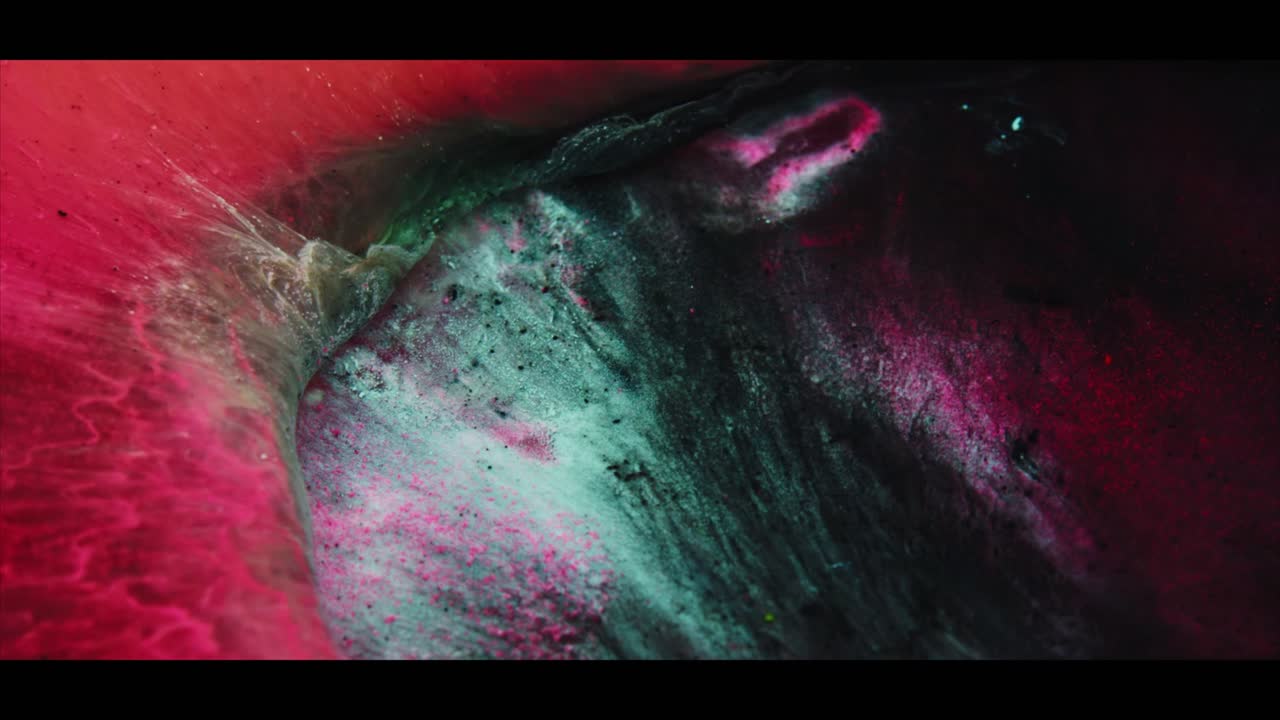 Dynamic Abstract Liquid Art with Red, Pink, and Teal Pigments