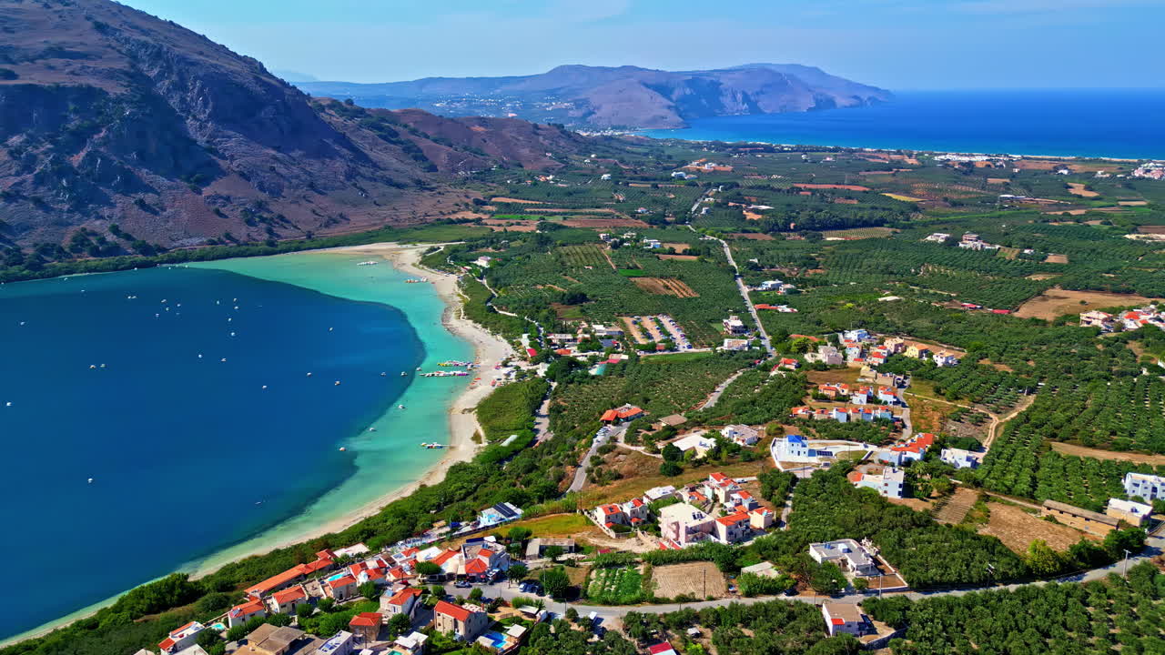 Lake Kournas Crete, Greece, with a panning reveal of the village of Kournas, landscape, and Agean Sea