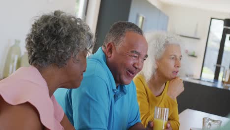 Happy-senior-diverse-people-having-breakfast-at-retirement-home