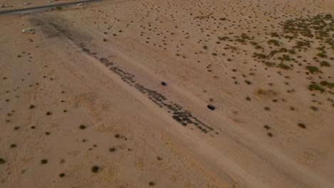 two cars in the desert, 4k drone video at salt lake desert valley