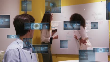 animation of graphs, radars, globe and computer language over diverse coworkers discussing in office