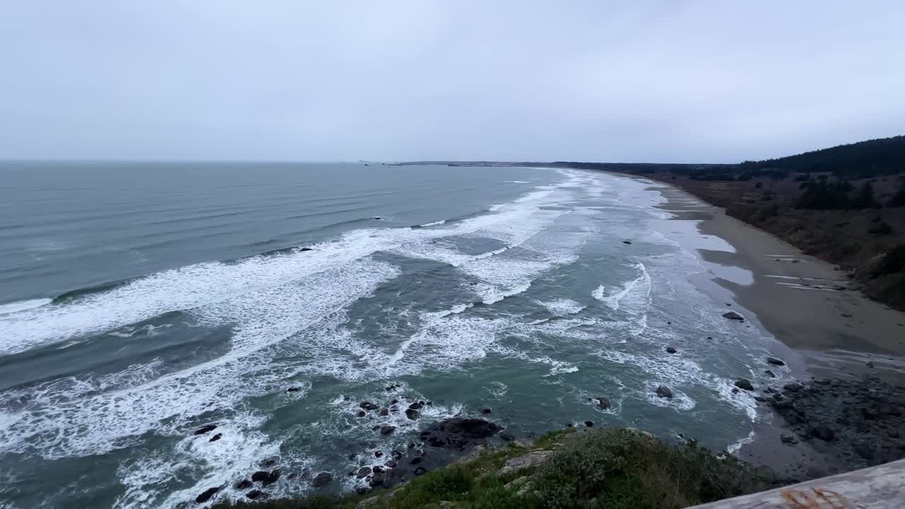 Handheld super wide angle panning shot of Crescent Beach on an overcast day in Crescent City, California. 4K