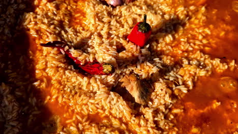 cooking spicy rice dish with chili peppers and garlic