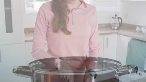 animación de zanahorias cayendo en la olla sobre una mujer caucásica cortando verduras en la cocina