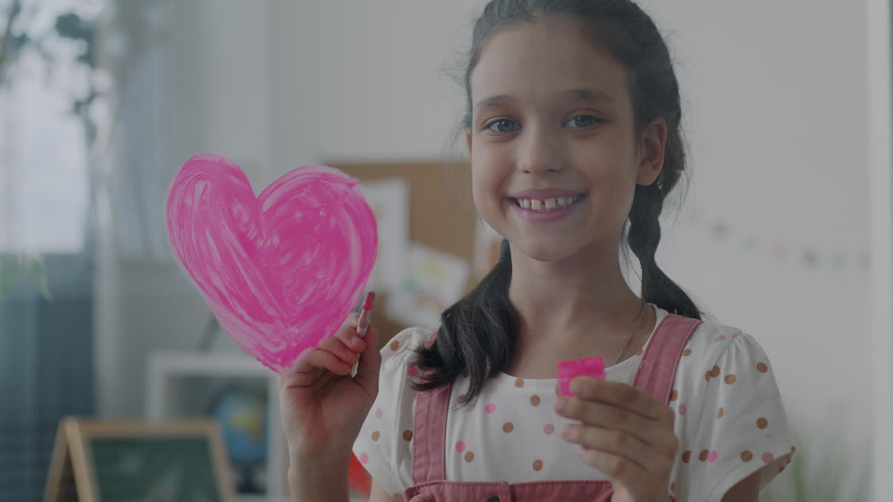 Smiling Girl Painting a Heart