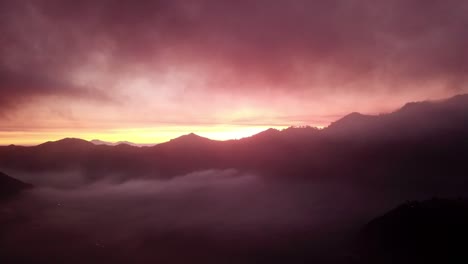 Sunset-by-drone-in-the-mountains-of-Indonesia,-With-clouds-and-beautiful-colours