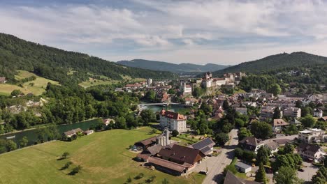 Scenic aerial view of Aarburg Castle, charming old town and Aare river in Canton Solothurn, Switzerland, surrounded by lush green hills under summer sky