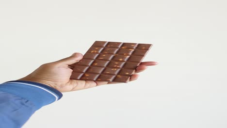 hand holding a chocolate bar