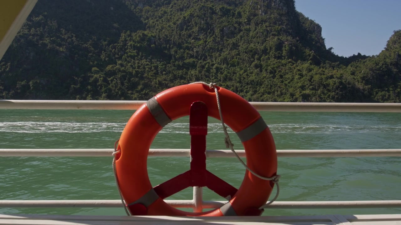 Orange Lifebuoy Mounted On The Ship's Railing For Emergency Rescue Situations In Ha Long Bay, Vietnam. Static shot
