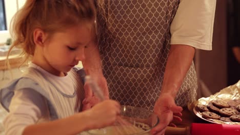 grandmother and granddaughter baking cookies