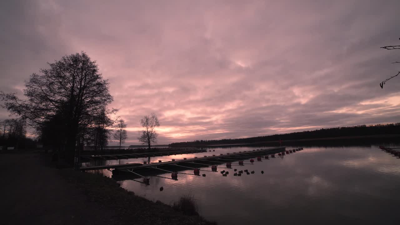 Timelapse of sunset over small harbor