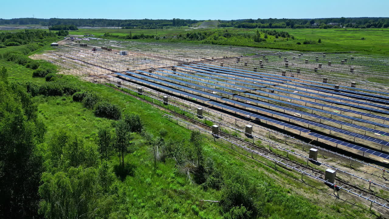 Solar park with solar panels on a green field. Aerial at daytime