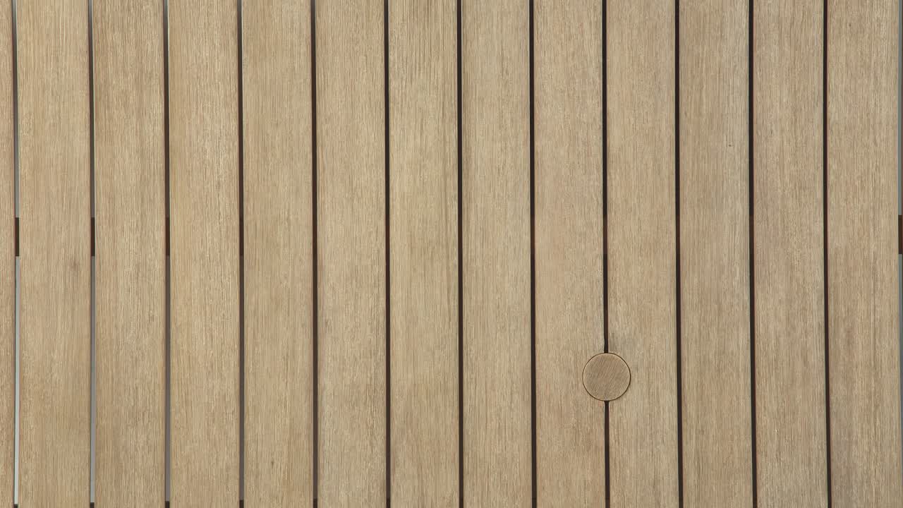 Static overhead frame captures the natural grain and clean lines of a weathered outdoor table