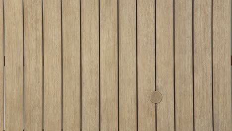 static overhead frame captures the natural grain and clean lines of a weathered outdoor table