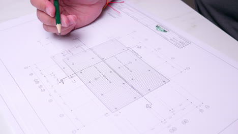 architect checking house construction blueprint plans