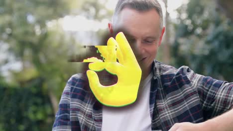 animation of hand icon over caucasian man using smartphone