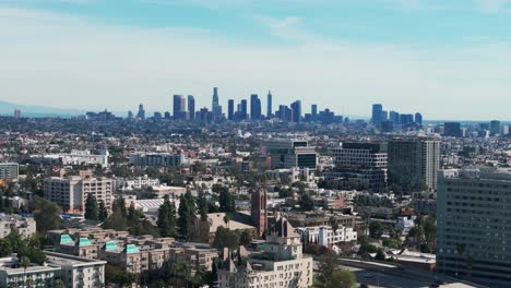 drone shot flying towards downtown los angeles, california during a sunny day